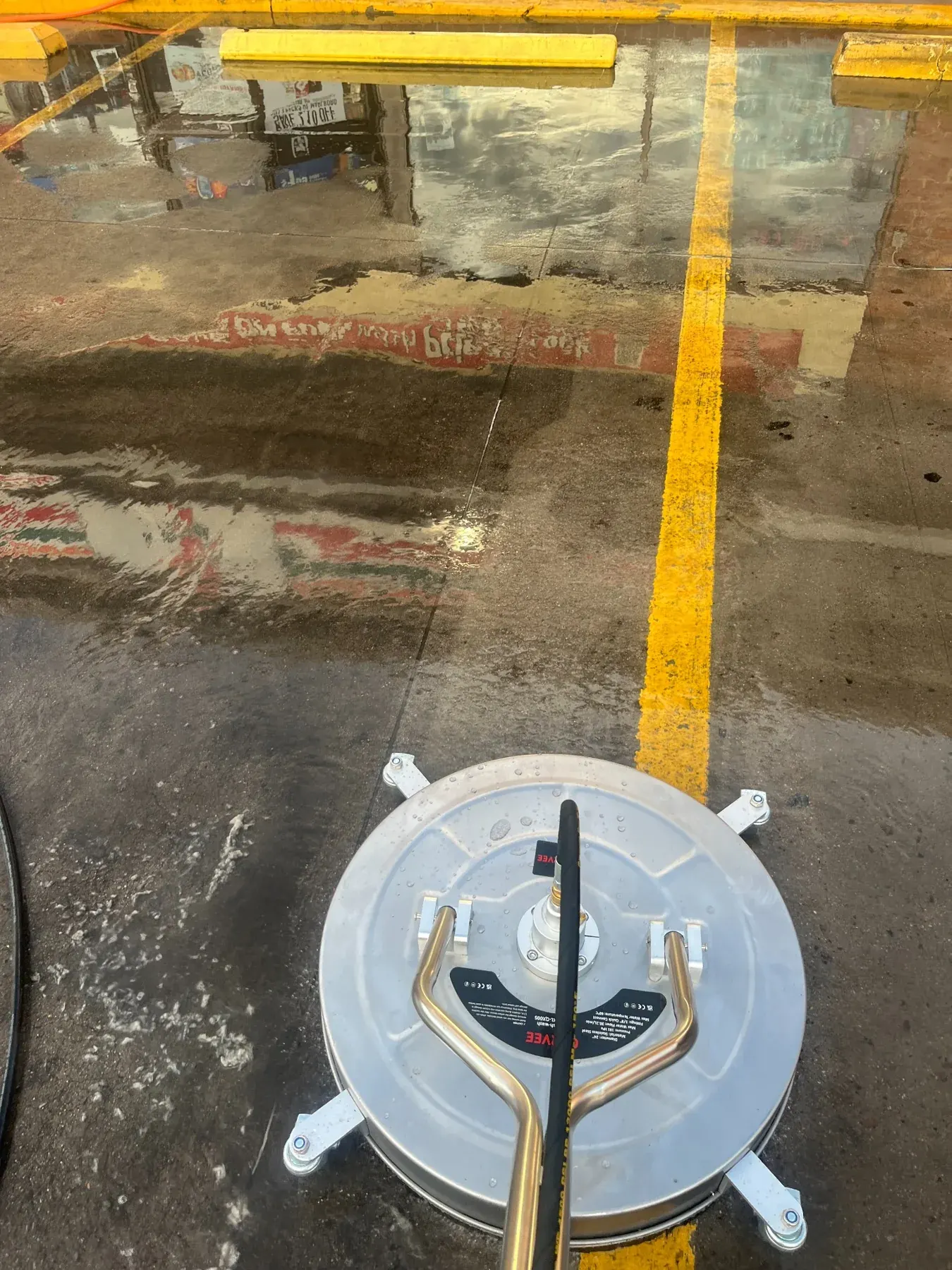 Surface cleaner washing marked concrete at a commercial property